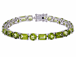 sterling silver 24.05ctw round and emerald cut peridot tennis bracelet.  the width measures 3/16 inch.  hidden box clasp.